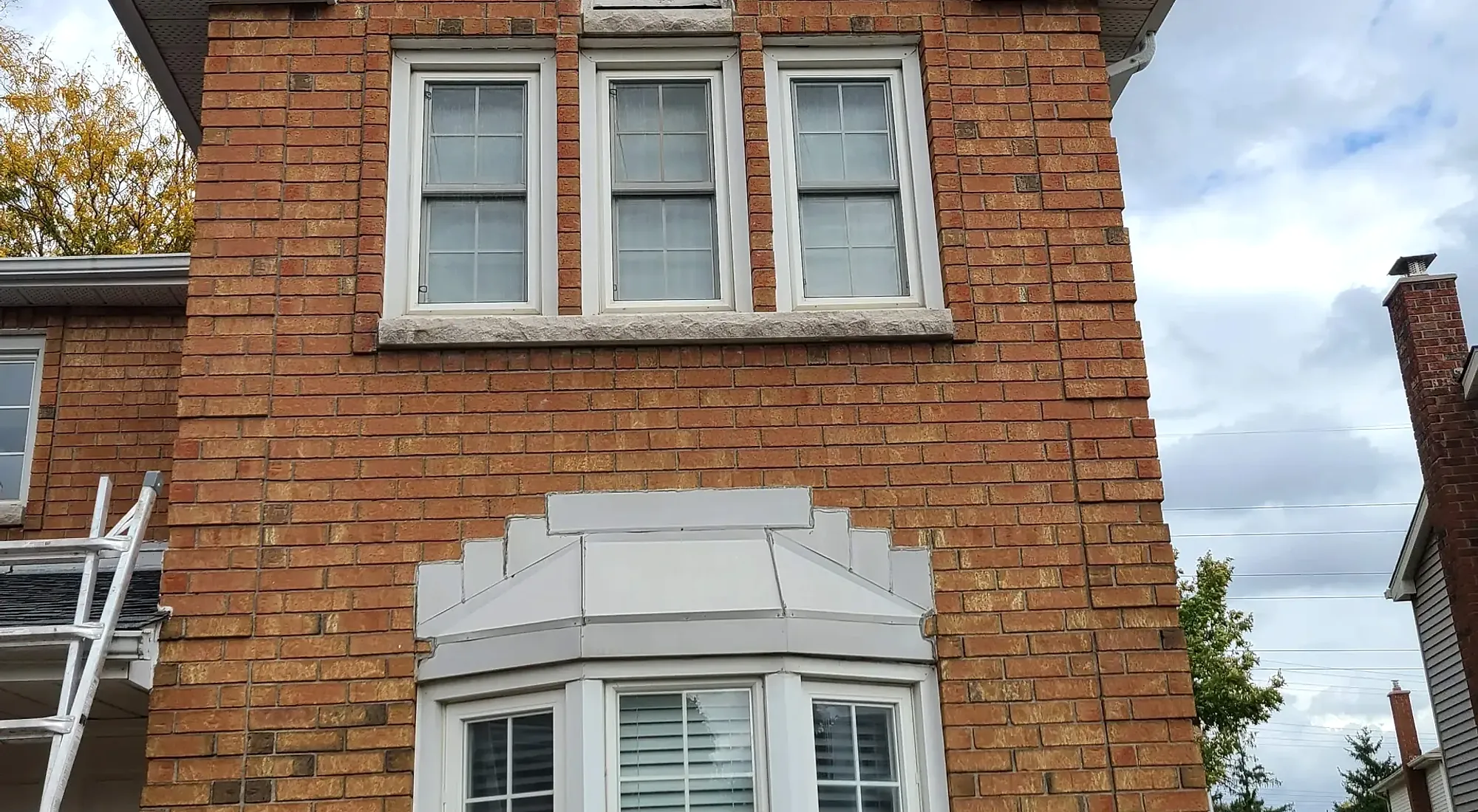 Century brick home with restored stone sills and lintels