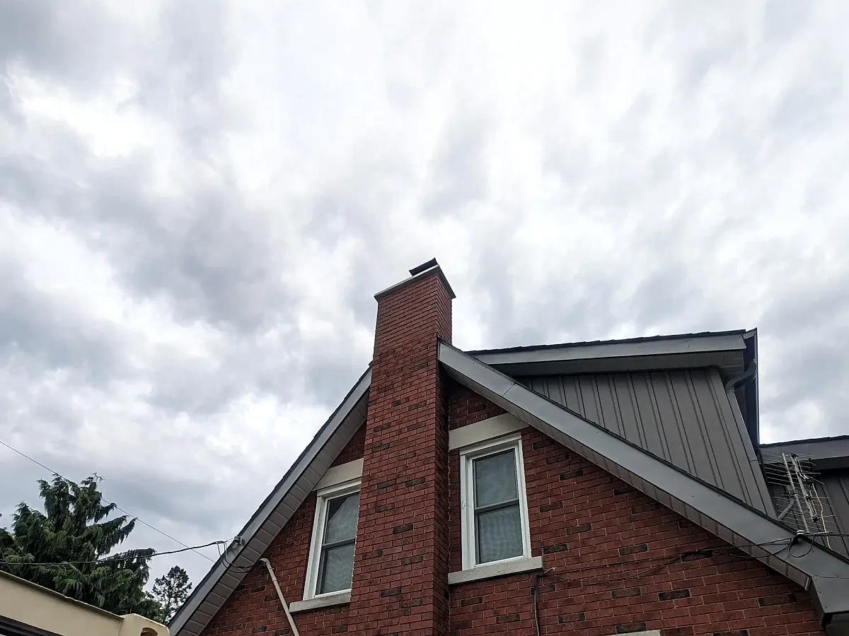 Rebuilt red brick chimney with fresh, evenly tooled mortar joints
