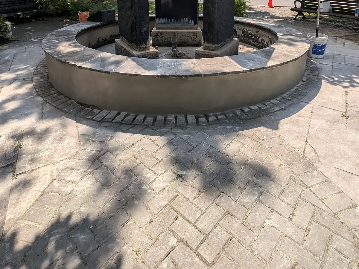 Raised circular paver terrace with stone pillars