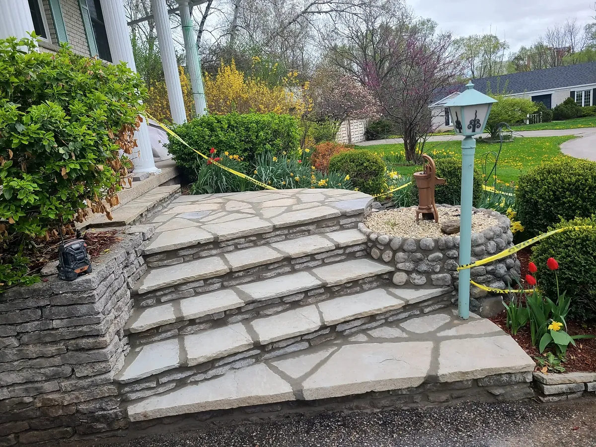 Natural stone garden steps leading up to a flagstone landing