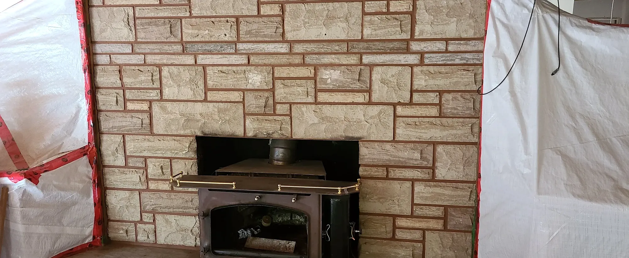 Interior stacked stone wall under construction