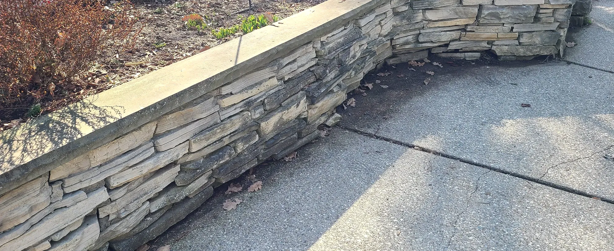 Low natural stone garden retaining wall